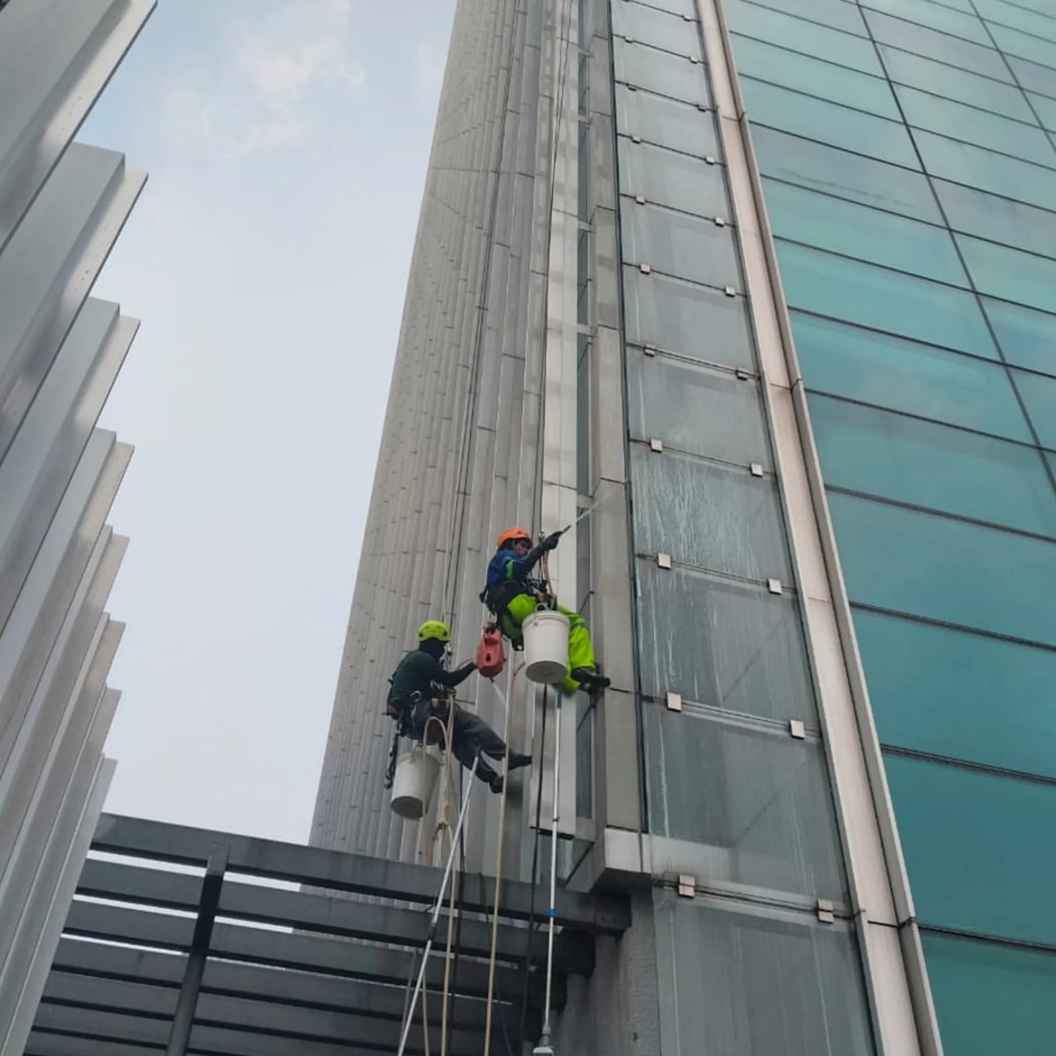 workers cleaning high-rise facade