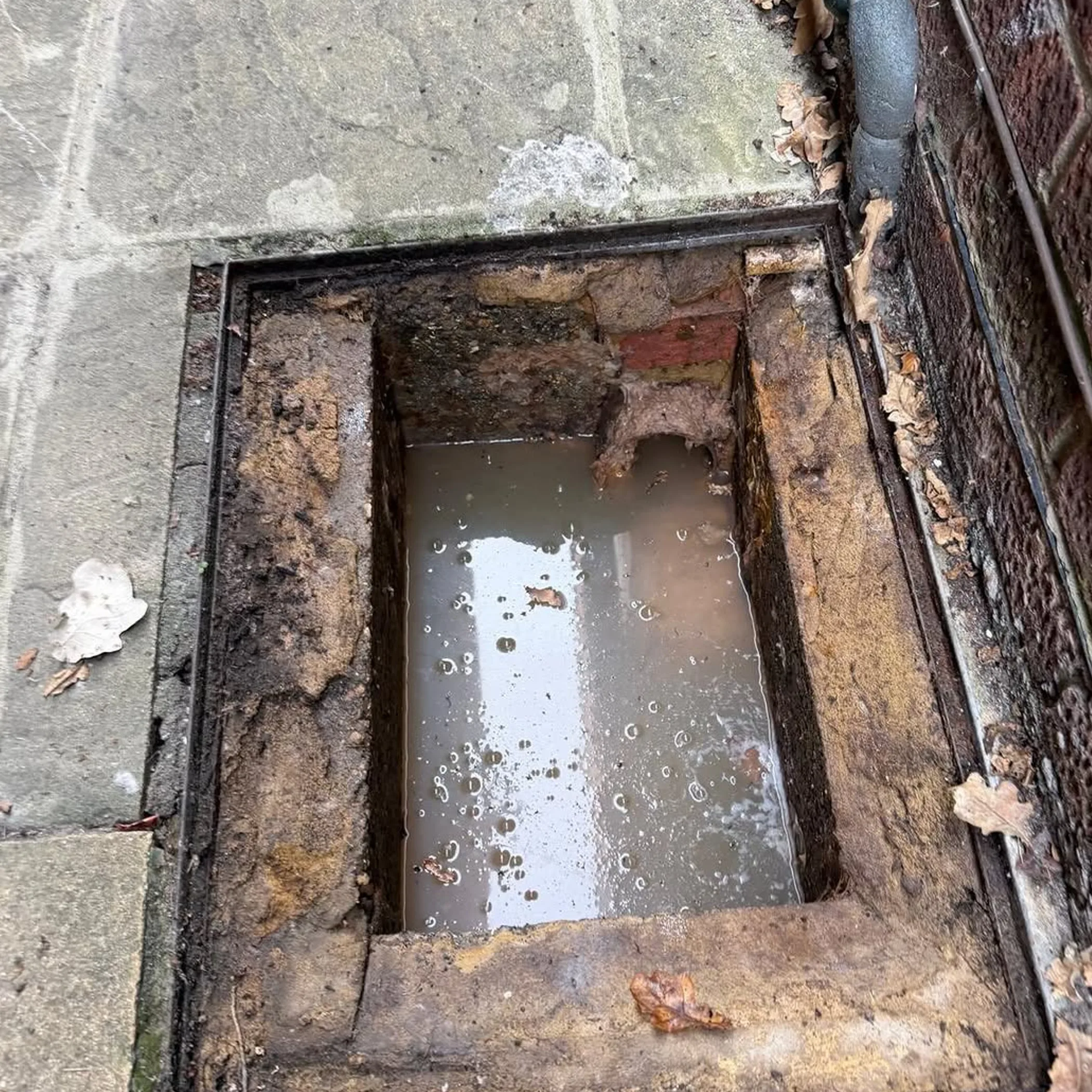 dirty water-filled stormwater drain
